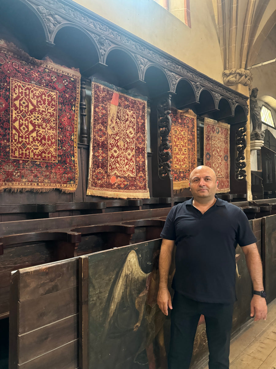 Hakan Karar of Ararat Rugs with historic Ottoman carpets in the Black Church, Brașov