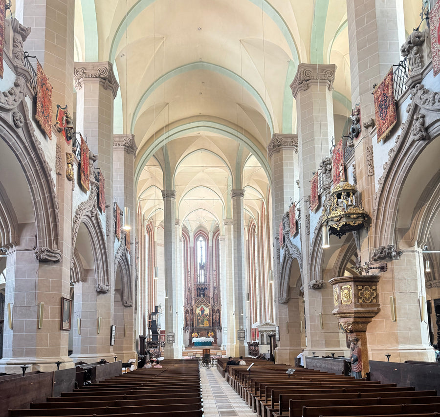 Interior of the Black Church in Brașov with Ottoman Anatolian rugs displayed above the nave