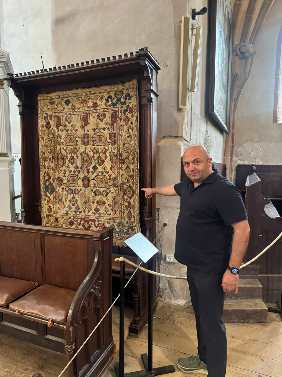 Hakan Karar studying an Ottoman Anatolian rug in the Black Church, Brașov